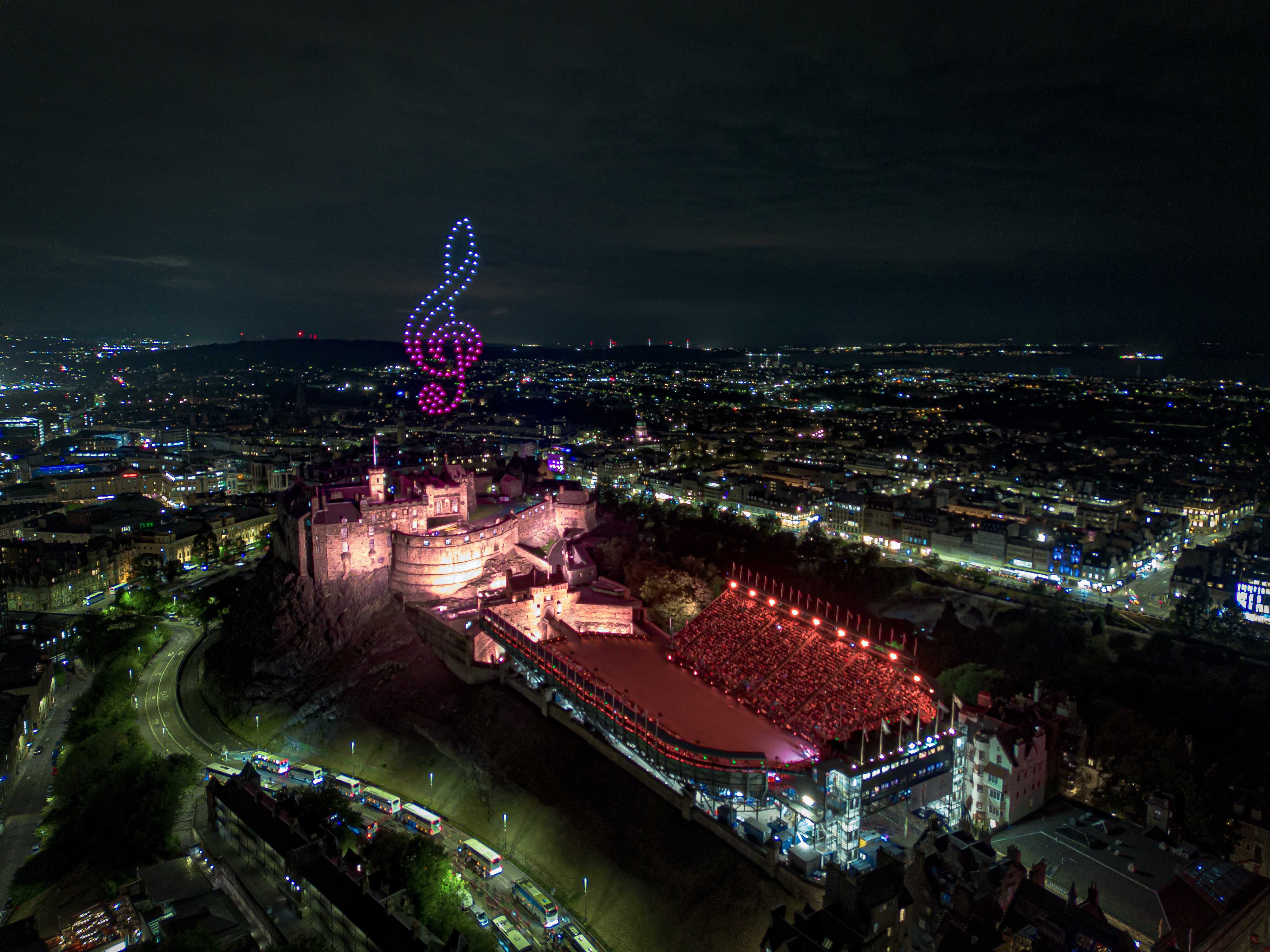100 drones flying over Edinburgh Castle for The Royal Edinburgh Military Tattoo forming a treble clef